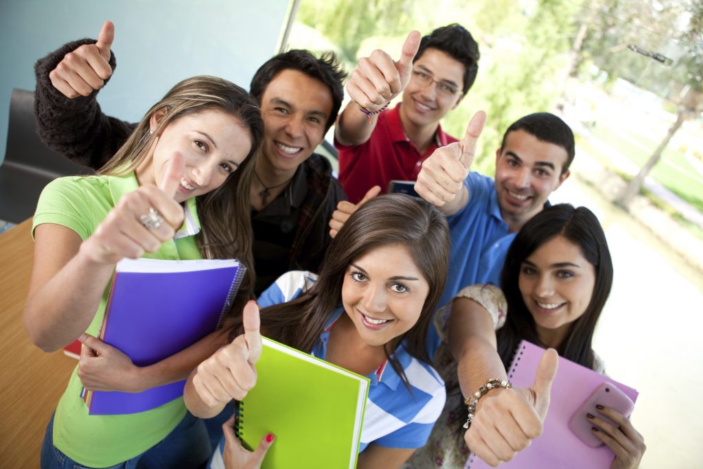 Group of students at the university with thumbs up